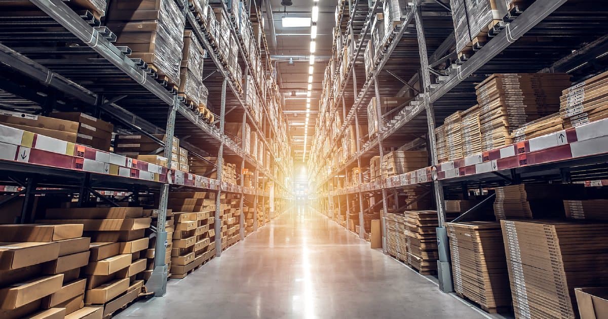 Rows of tall warehouse shelves stacked with boxes