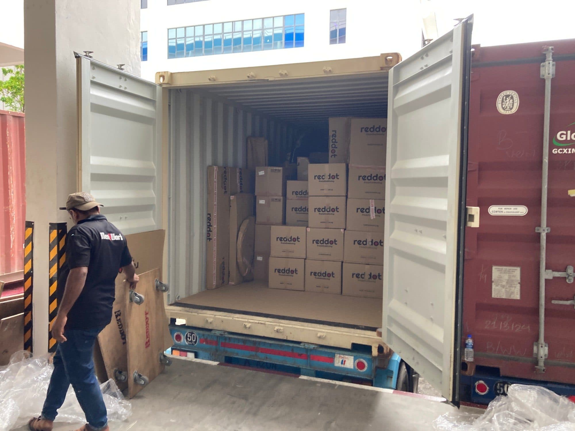 An open shipping container packed with Reddot boxes