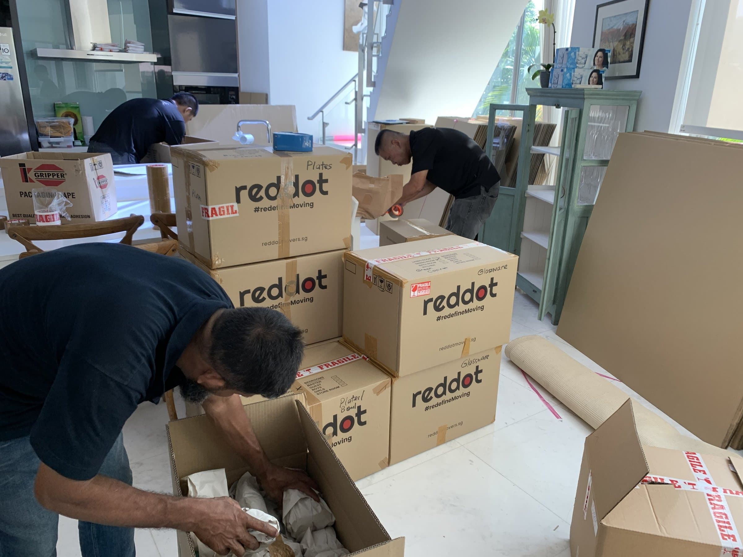 Reddot Movers crew packing items into Reddot boxes