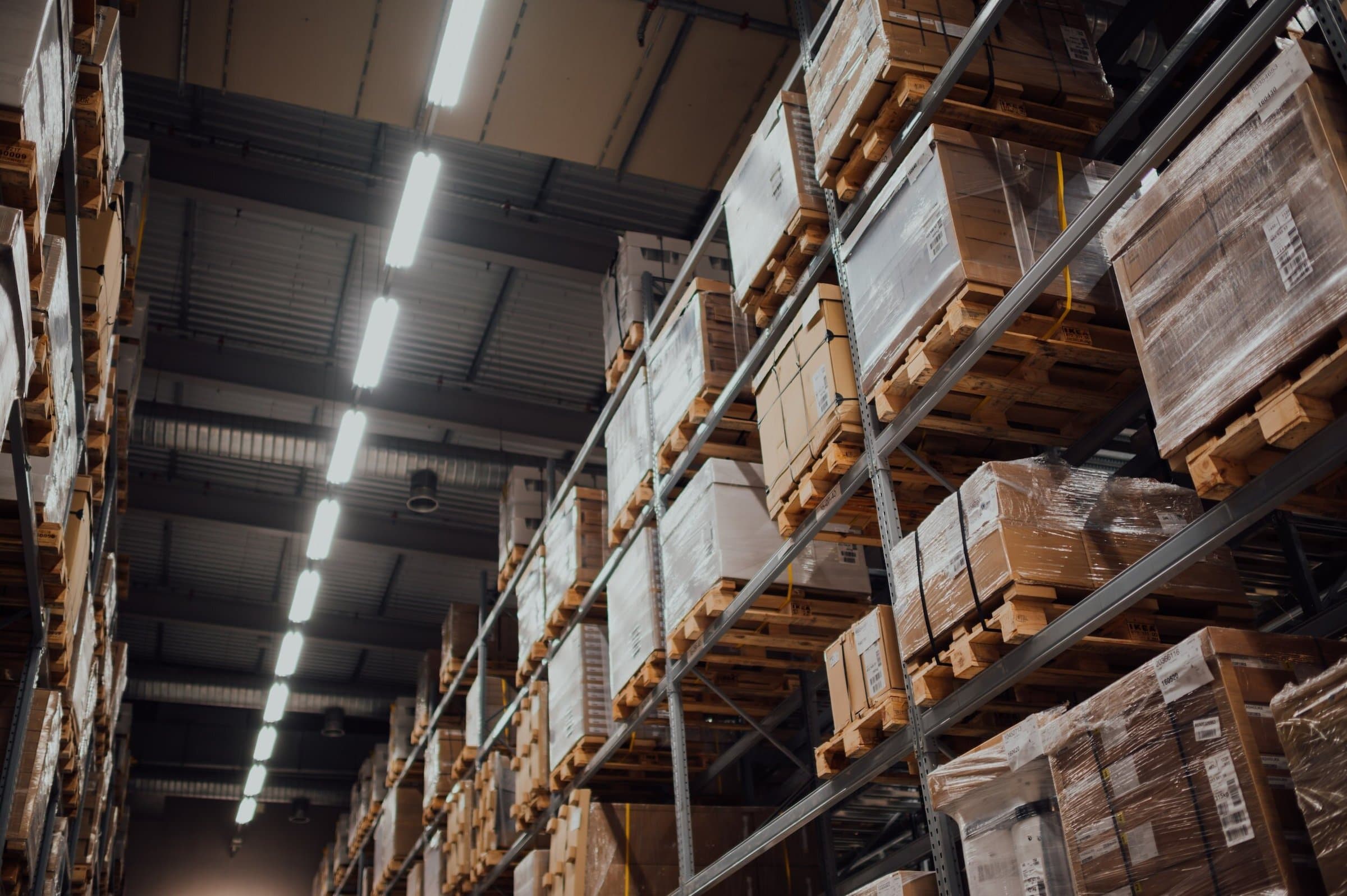 Tall warehouse racks of boxed goods on pallets