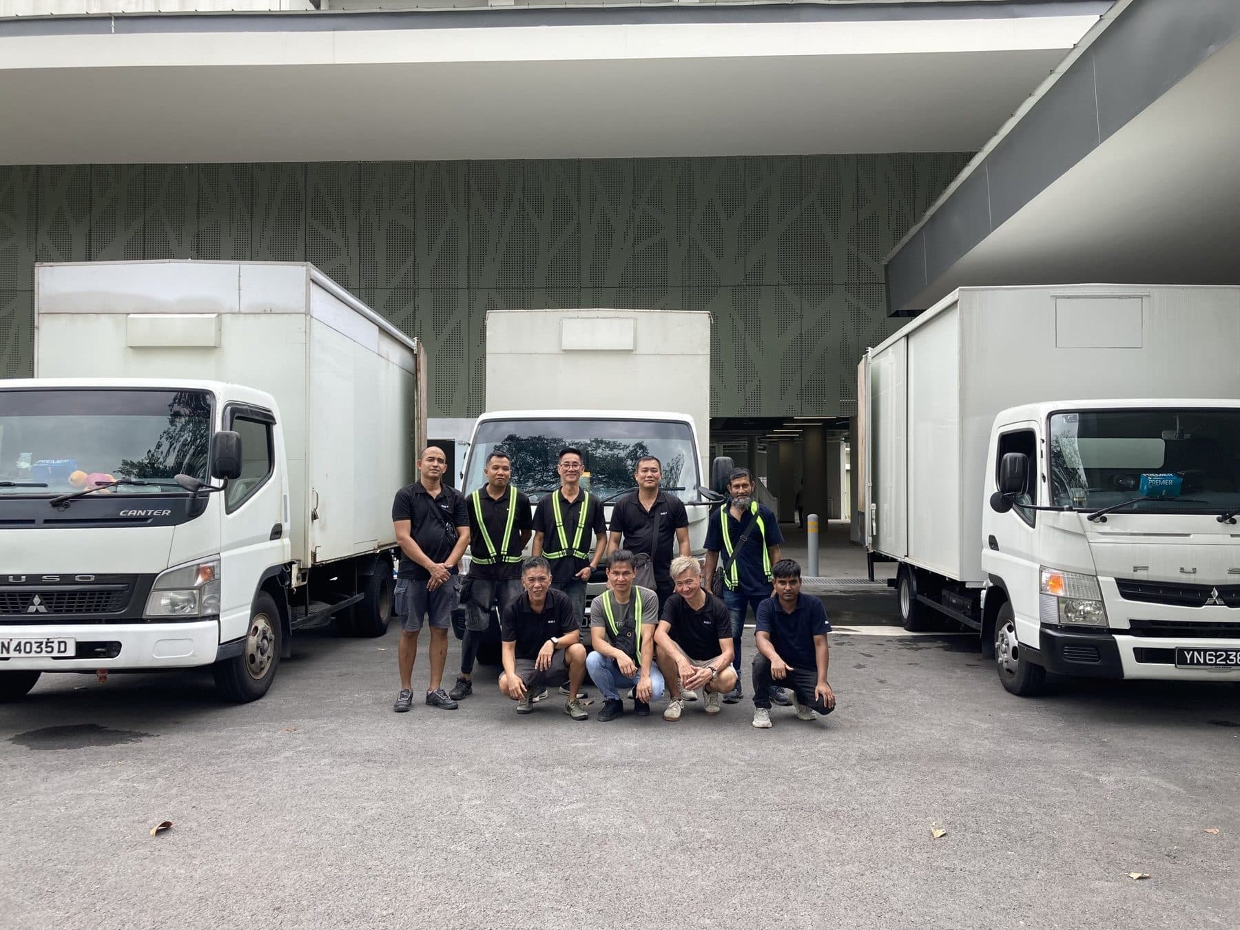 The Reddot crew in front of three company trucks