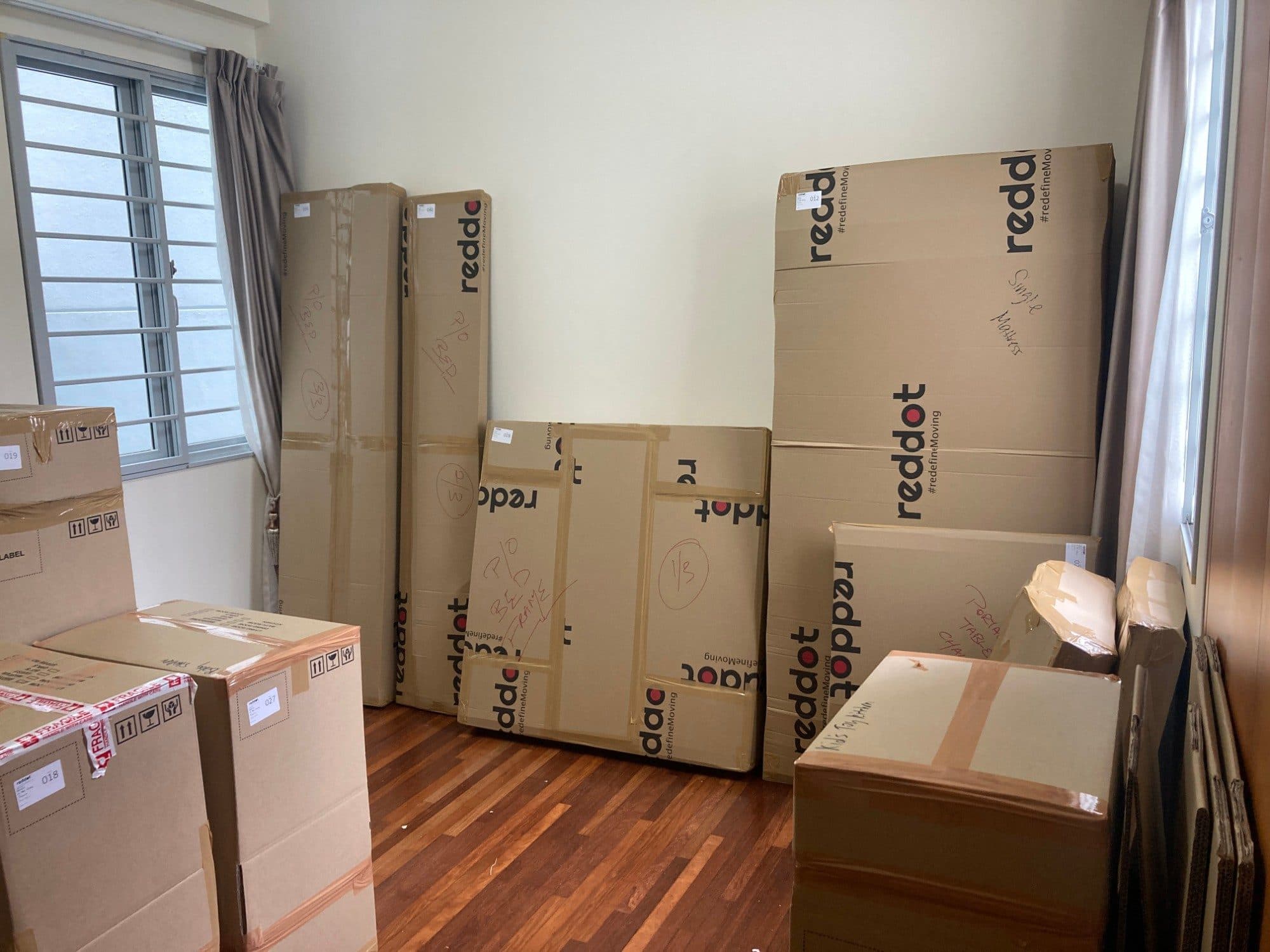 A bedroom of Reddot boxes packed and labelled for a move, including a bed frame and mattress